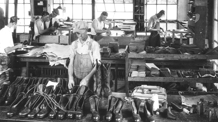 Men work on Justin boots in factory 