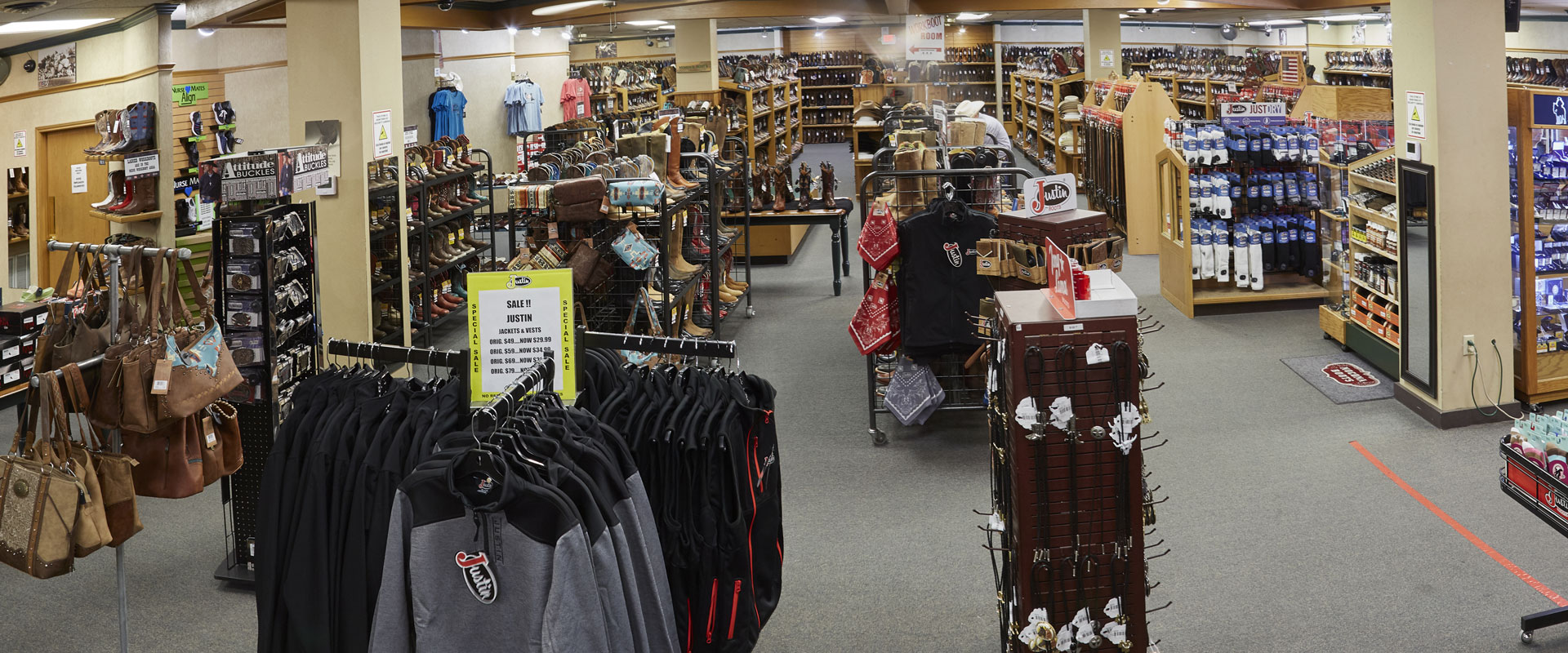 Racks of bags, shoes and clothing in Justin factory store 