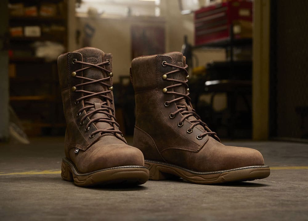 Men’s Rush 8” Lace Up Nano Comp Toe work boot in brown posed in a work space on concrete.