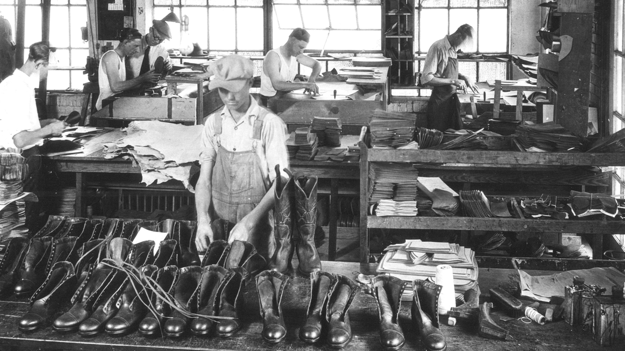 Men work on Justin boots in factory 