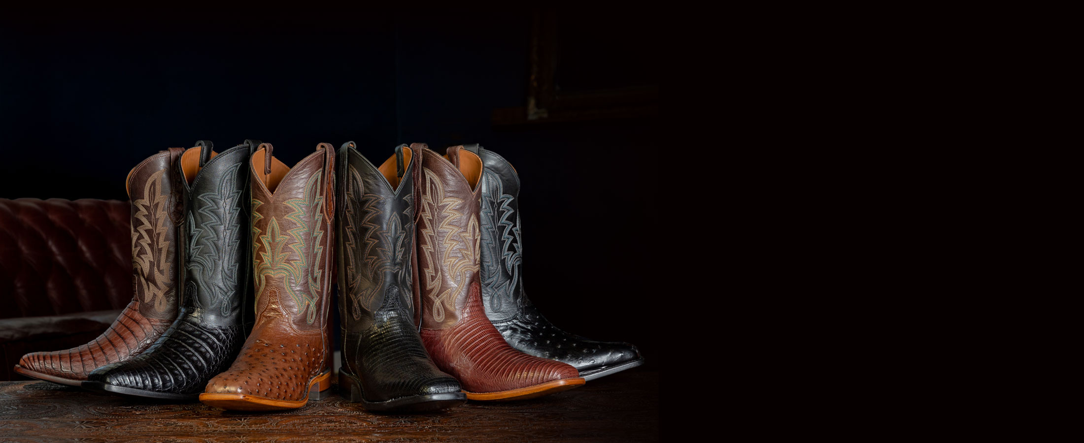 Panama 12" Caiman Cowboy in black and brown, Rancher 12" Ostrich Cowboy in black and brown, Reposado 12" Lizard Cowboy in black and brown posed in a circle.