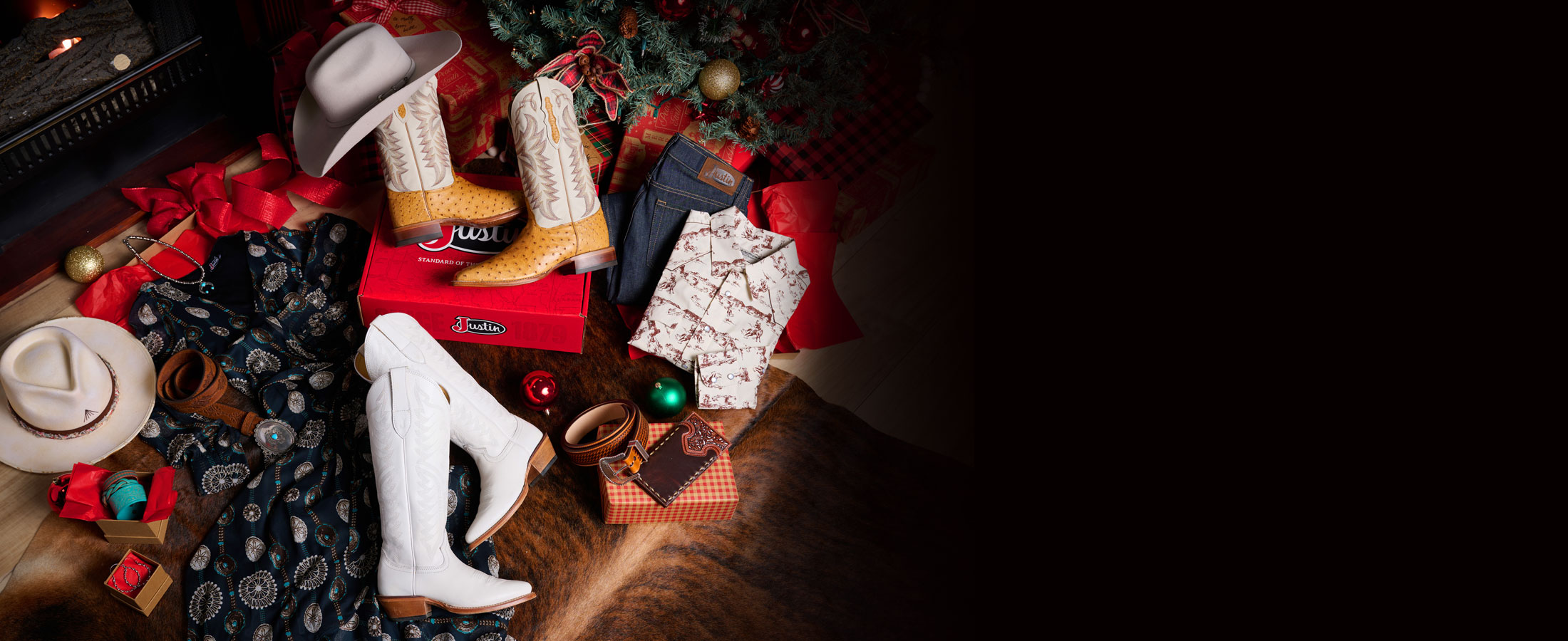 Pasco 13” tan smooth ostrich boots, a hat, cream snap shirt, unwashed blue straight-leg jeans, and Evelyn Vintage Ivory 15” cowhide boots, under a Christmas tree.