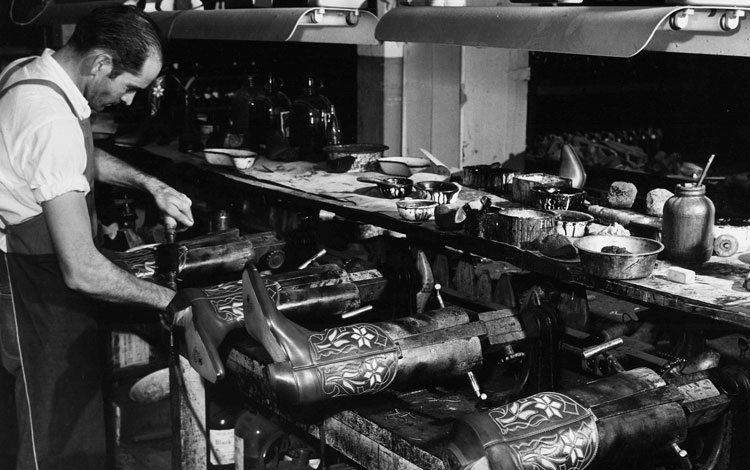 Man making boots in factory 