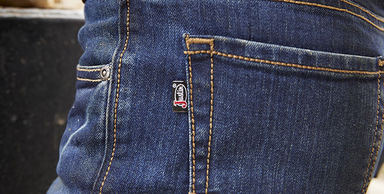 A close up of a man wearing Justin Jeans.