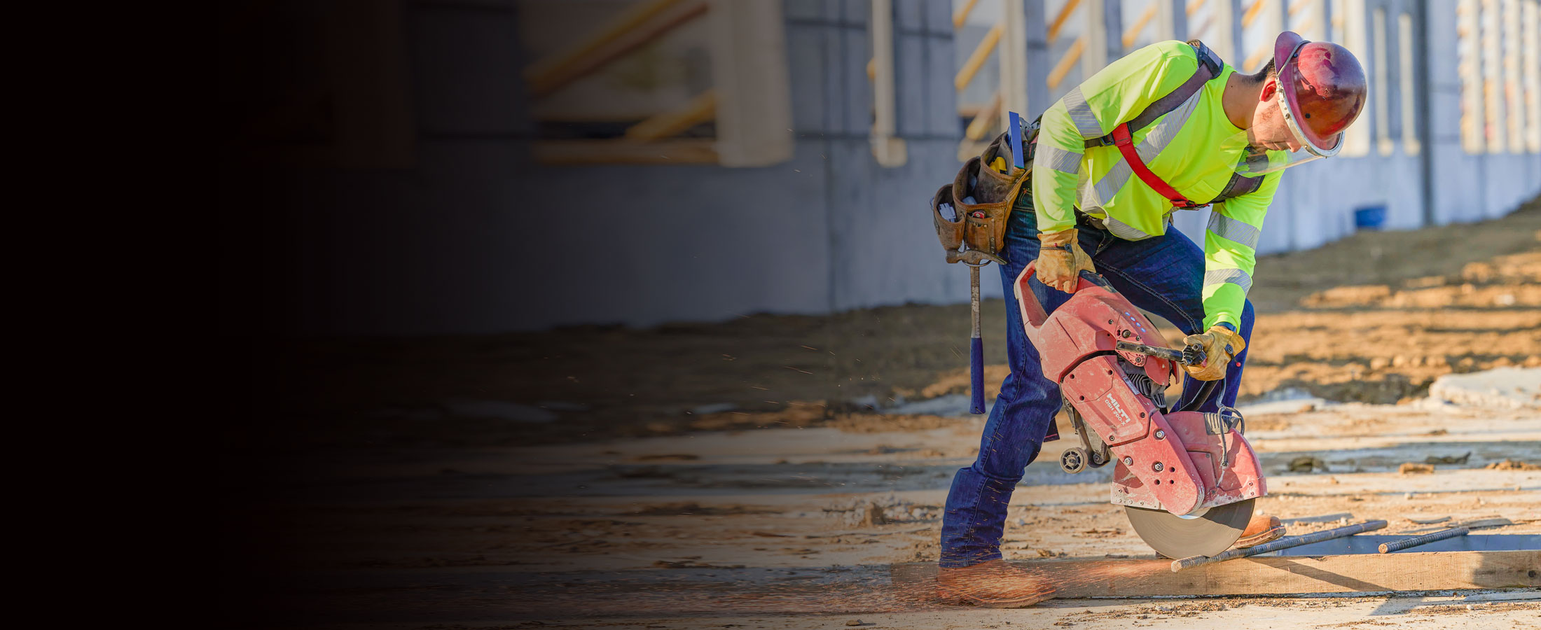 A man wearing 1879 Straight Leg Men’s Jeans and safety gear using machinery with sparks.