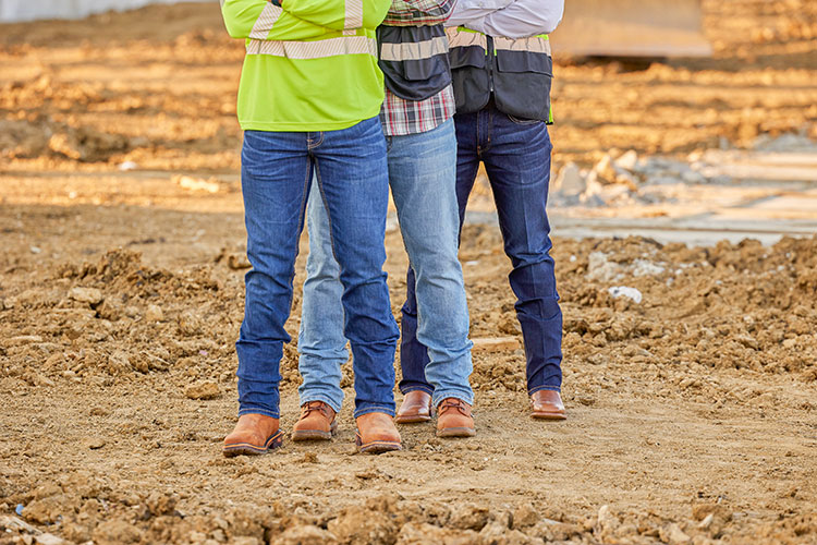 Three men wearing Justin Jeans and Justin boots.