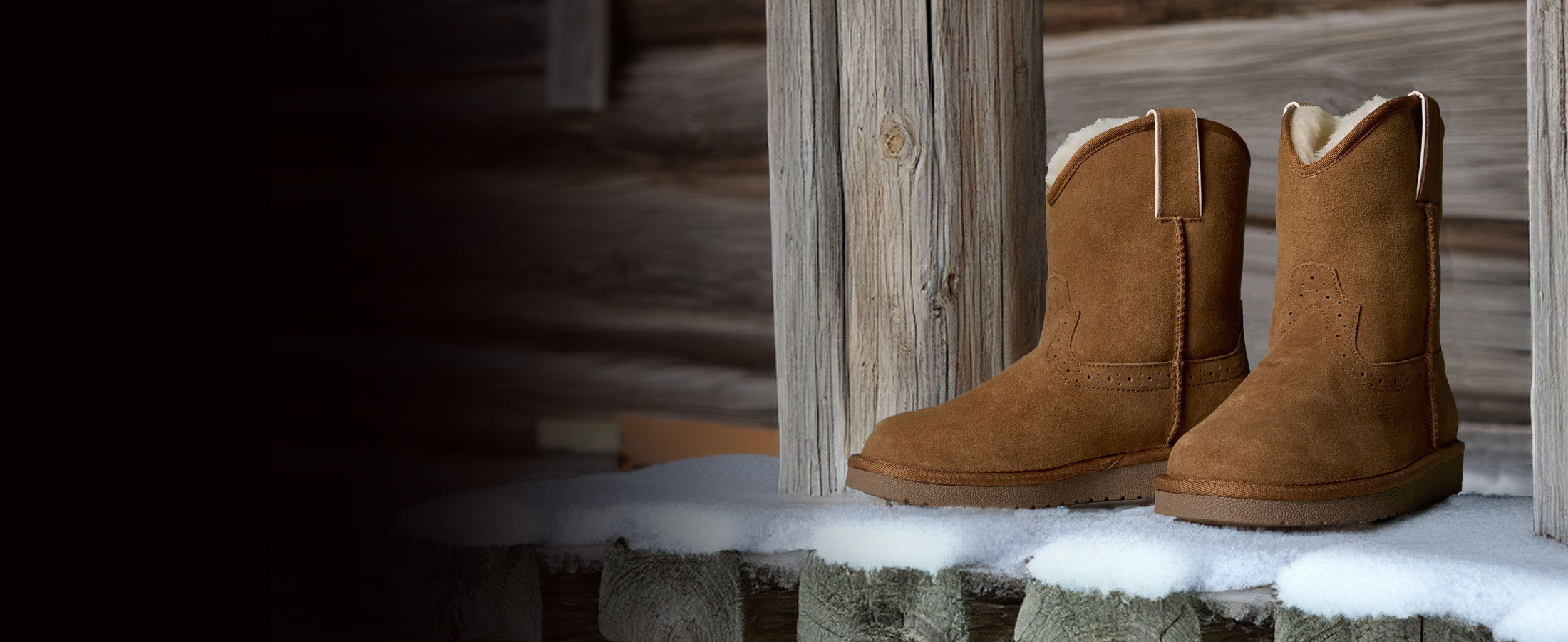 Justin gypsy shearling lined boots on a porch made of wood.