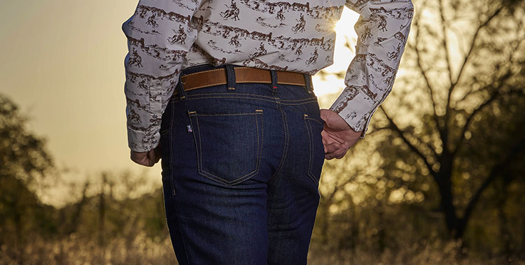 A close up shot of a man wearing Justin Jeans.