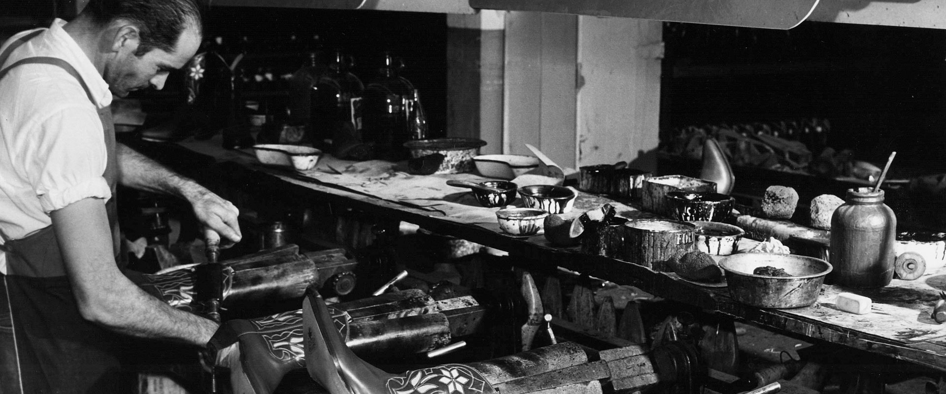 Man making boots in factory 