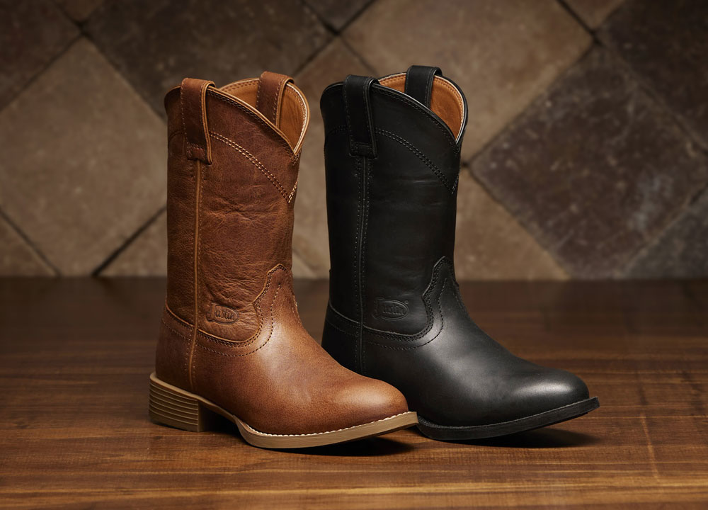 A Justin Stampede Roper in brown and a Justin Stampede Roper in black on a wood floor.