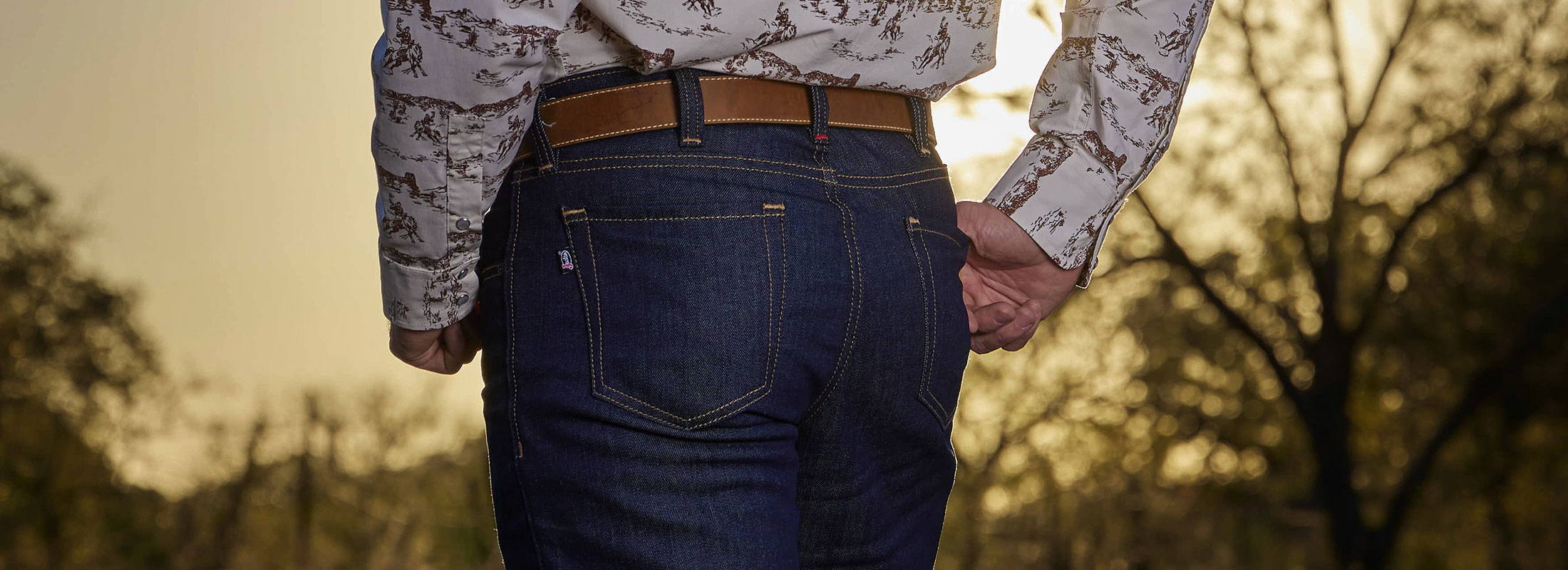 A close up shot of a man wearing Justin Jeans.