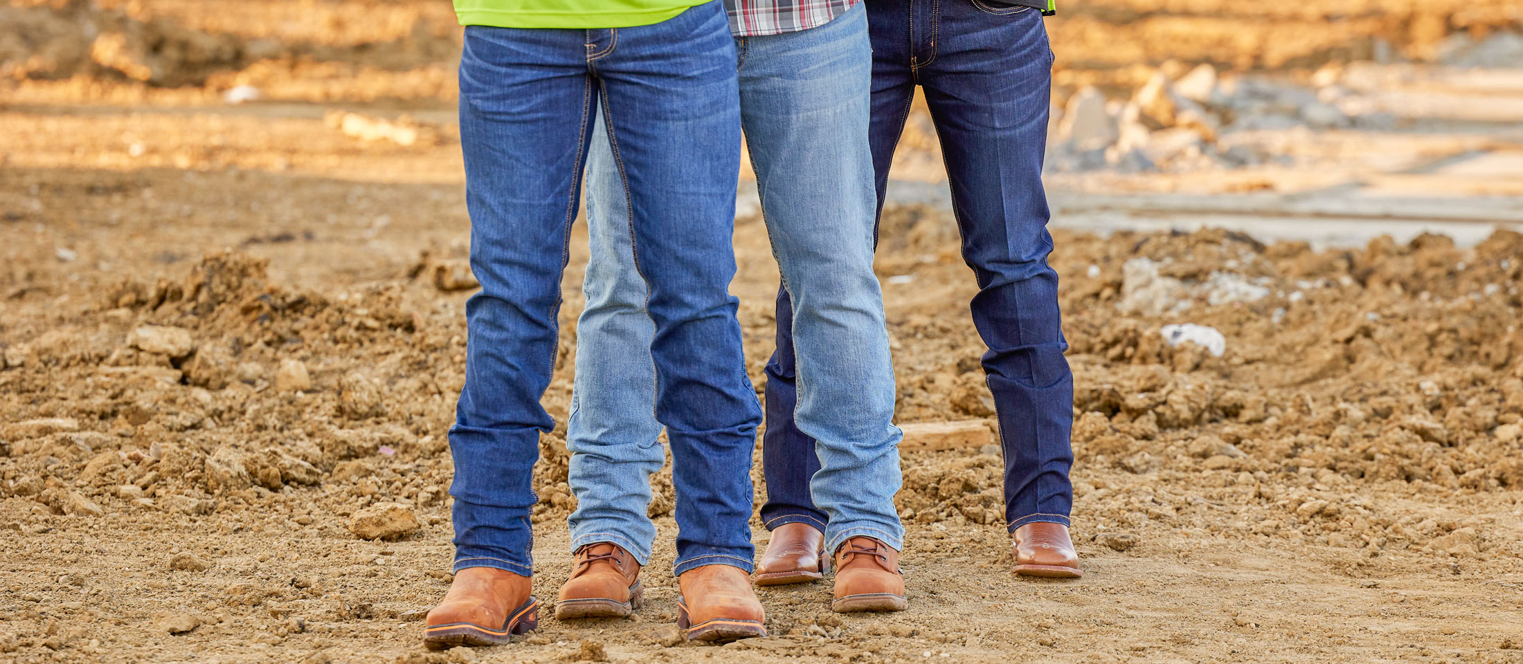 Three men wearing Justin Jeans and Justin boots.