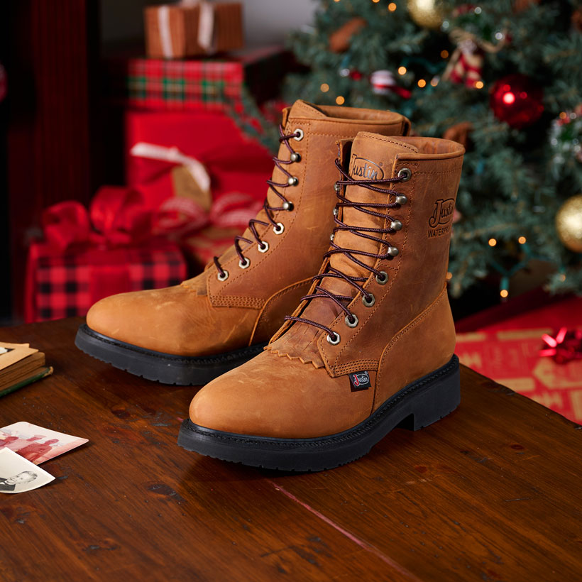 Livestock 8" Waterproof in aged bark brown posed on a wooden table with a Christmas scene behind it. 