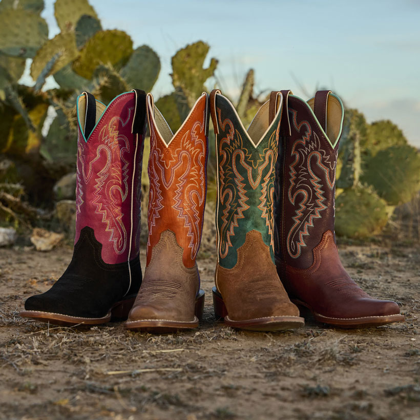 The Men’s Frontier Collection of boots displayed in front of a cactus scene.