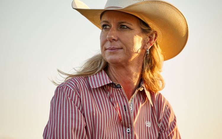 Sherry wearing cowboy hat and button up