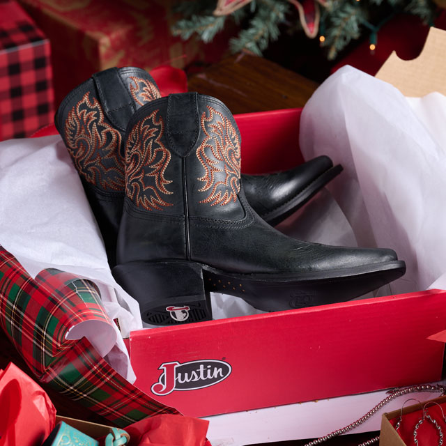 Justin Boots Vintage Collection Isabella 7-inch Bootie in Coal (Black) beautifully presented in a holiday setting. Shop Isabella.